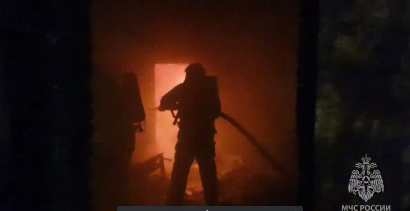 Пожарные тушат огонь в здании.