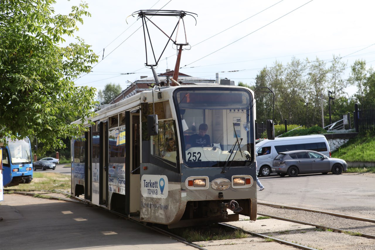 Трамвай на улице в солнечную погоду.