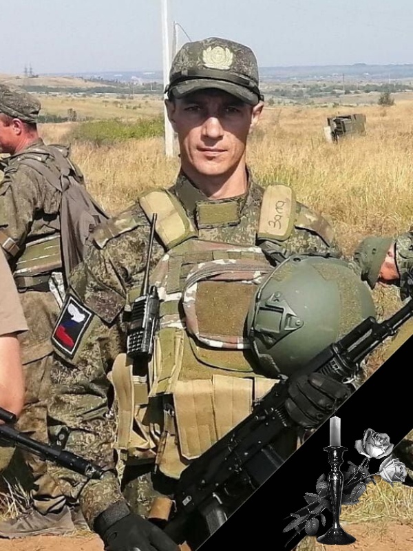 Российский солдат в поле с оружием.